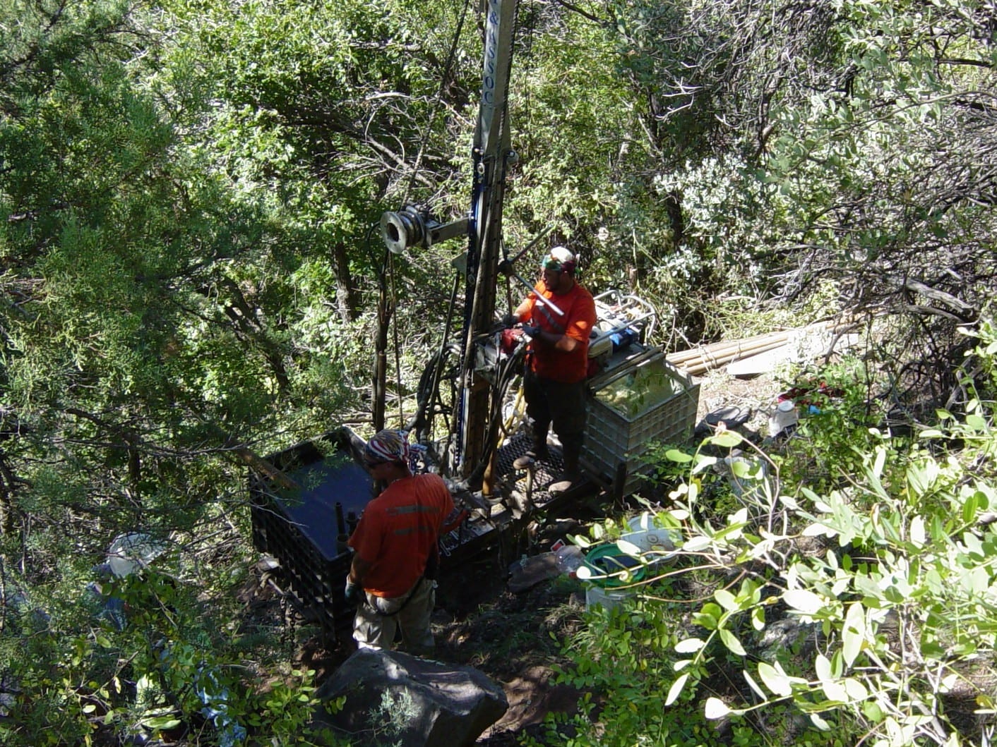 Small footprint drill rig located on a steep heavily wooded slope